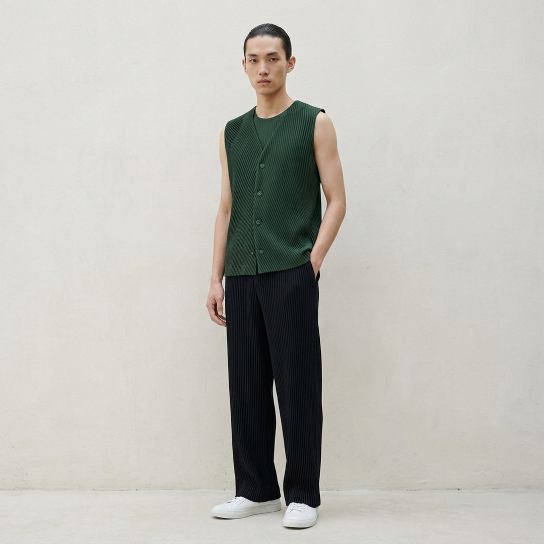Homme Plissé Issey Miyake Slash Pleated Vest in black, featuring a chevron V-formation pleat pattern, V-neckline, and tonal button-front placket, displayed flat on a white background - lifestyle