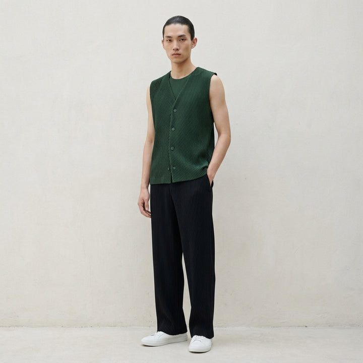 Homme Plissé Issey Miyake Slash Pleated Vest in black, featuring a chevron V-formation pleat pattern, V-neckline, and tonal button-front placket, displayed flat on a white background - lifestyle