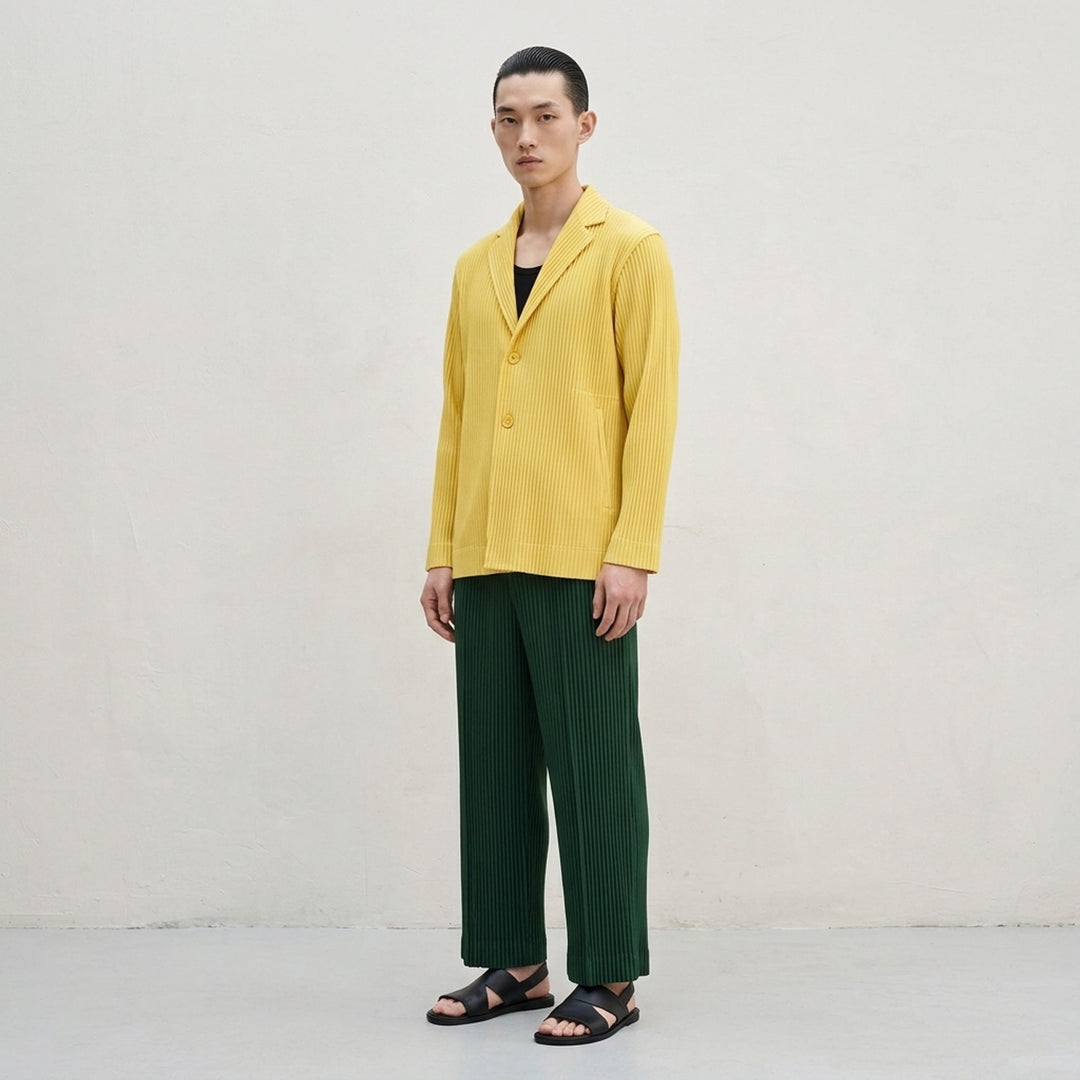 Homme Plissé Issey Miyake Tailored Pleats 2 yellow pleated jacket with notched lapels and two-button front, shown front view - lifestyle