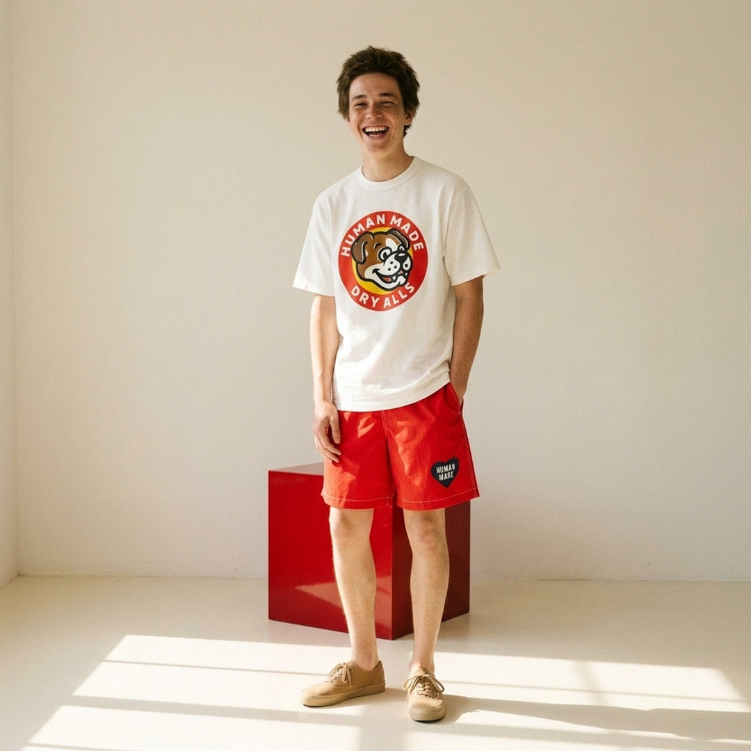 Human Made Dry Alls Graphic Tee in black, featuring a large circular bulldog mascot badge print at the chest with red, yellow, and white detailing - lifestyle