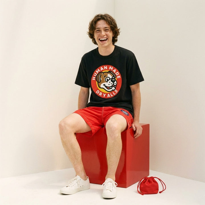 Human Made Dry Alls Graphic Tee in black, featuring a large circular bulldog mascot badge print at the chest with red, yellow, and white detailing - lifestyle