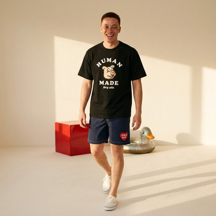 Human Made black short sleeve crew neck tee with smiling pig mascot graphic and arched 'Human Made Dry Alls' slogan print on the chest - lifestyle