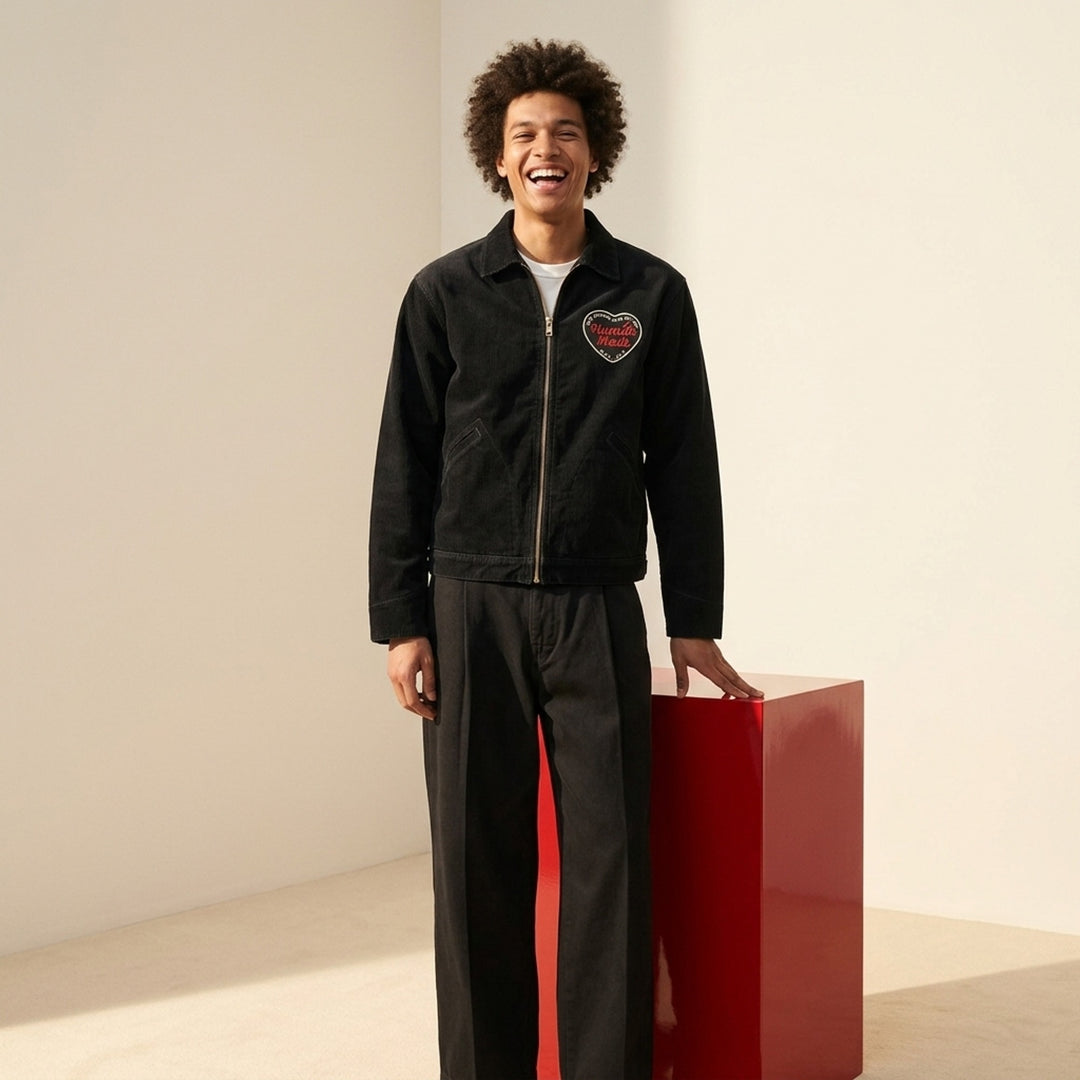 Human Made black zip-up work jacket with corduroy collar, brass two-way zip and embroidered red and white heart logo patch on the chest - lifestyle