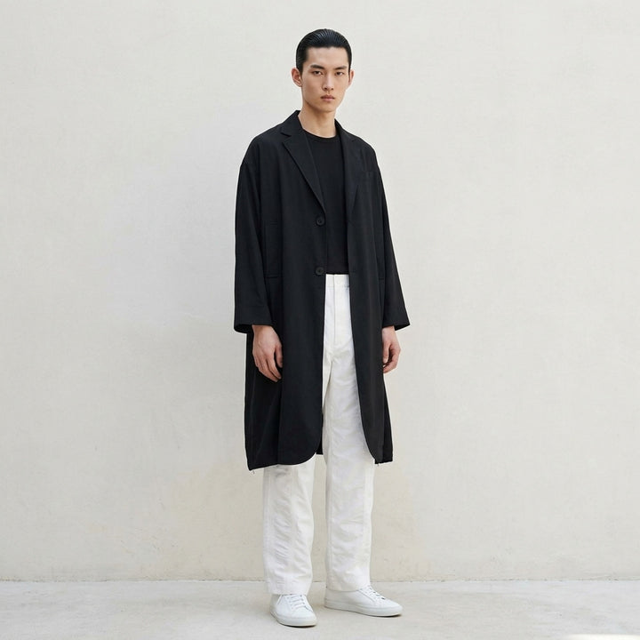 IM Men Breeze Drape Coat in black — oversized A-line silhouette with notched lapels, two-button closure, patch pockets, three-quarter sleeves, and hem zip vents - lifestyle