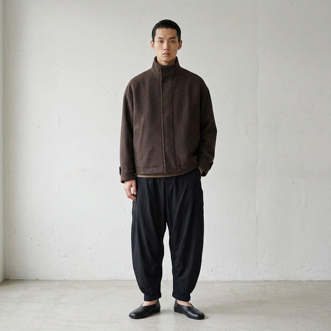 IM MEN Fuller Wool Blouson in black with stand collar, concealed button placket and slanted welt pockets, shown from the front - lifestyle