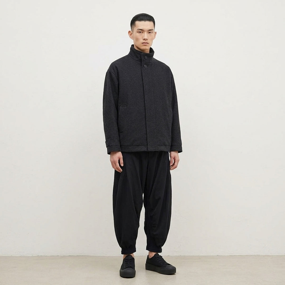 IM MEN Fuller Wool Blouson in black with stand collar, concealed button placket and slanted welt pockets, shown from the front - lifestyle