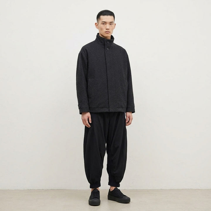 IM MEN Fuller Wool Blouson in black with stand collar, concealed button placket and slanted welt pockets, shown from the front - lifestyle
