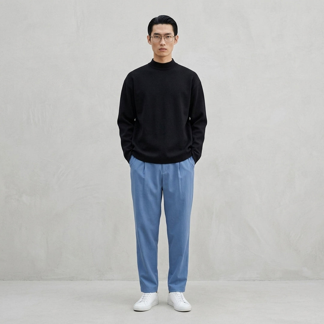 IM MEN MONO-MILANO black long-sleeve Milano knit top with mock turtleneck collar and relaxed oversized silhouette, front view - lifestyle