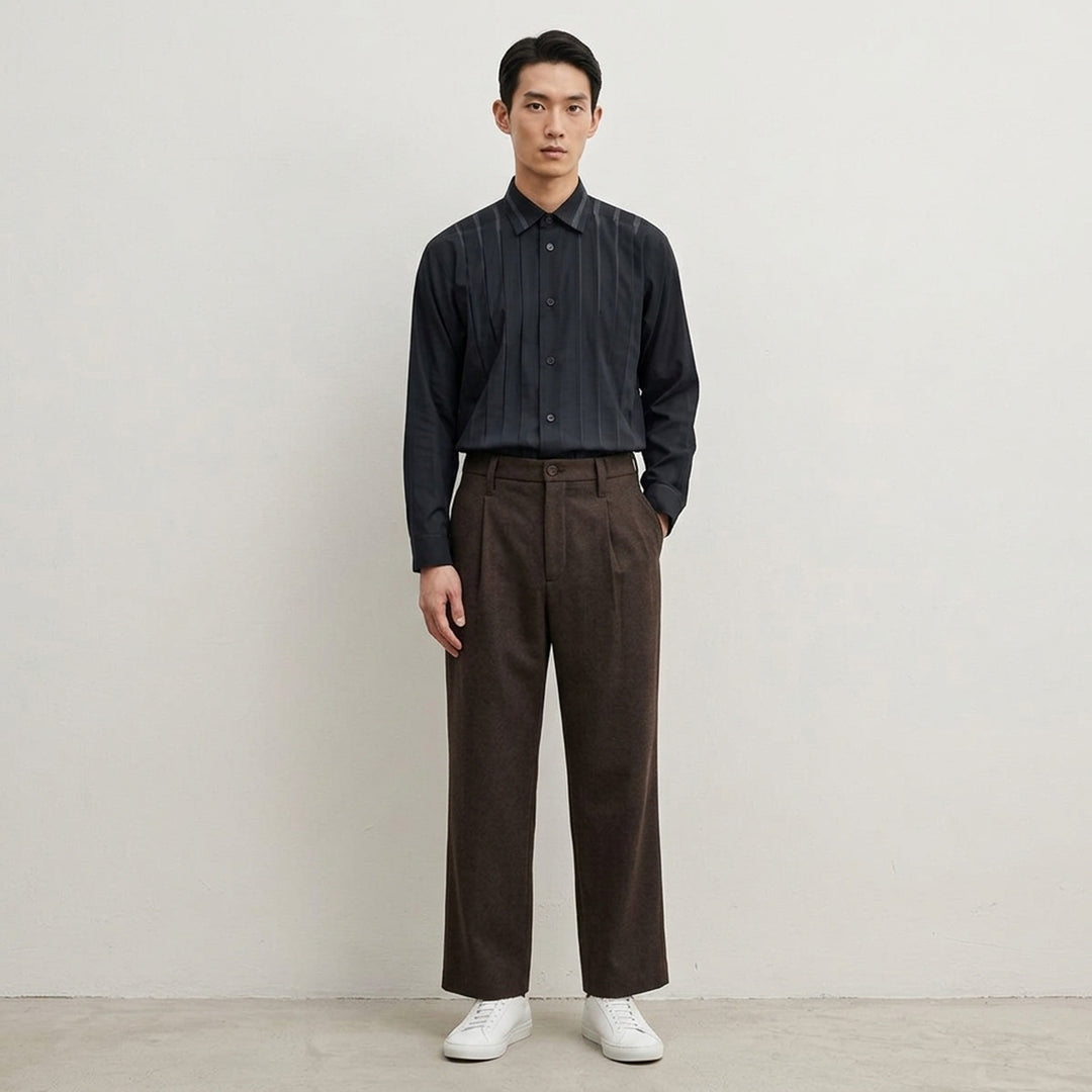 IM Men Shrink Wool woven pants in black with a front pleat, button closure and straight leg, shown from the front - lifestyle