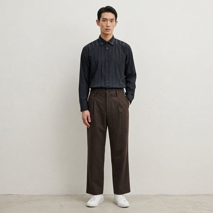 IM Men Shrink Wool woven pants in black with a front pleat, button closure and straight leg, shown from the front - lifestyle