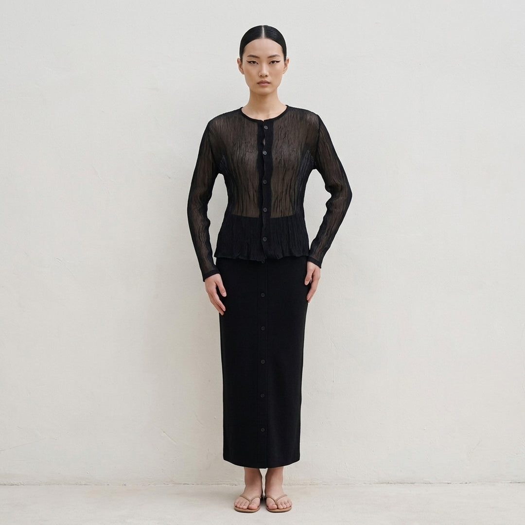 Issey Miyake sheer black chiffon twist cardigan with crinkled pleated texture, round neckline and button-front closure - lifestyle