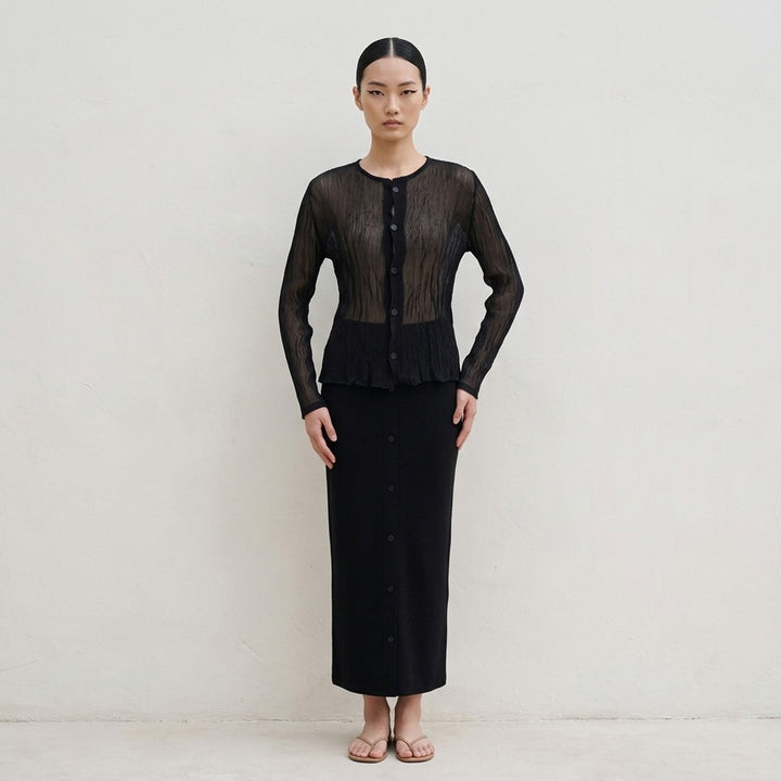 Issey Miyake sheer black chiffon twist cardigan with crinkled pleated texture, round neckline and button-front closure - lifestyle