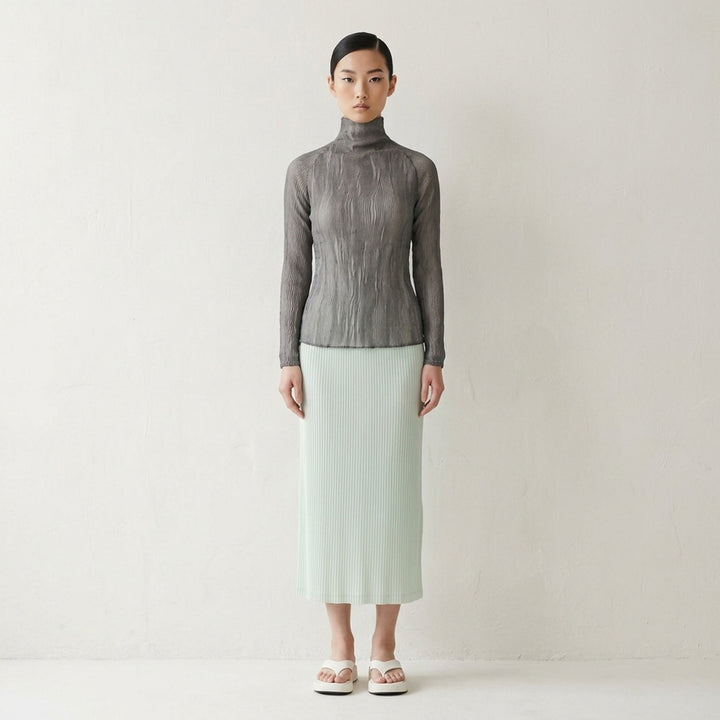 Rear view of Issey Miyake Chiffon Twist 2 woven top in grey, featuring fine horizontal pleating, a high funnel neck, and long fitted sleeves on a mannequin - lifestyle