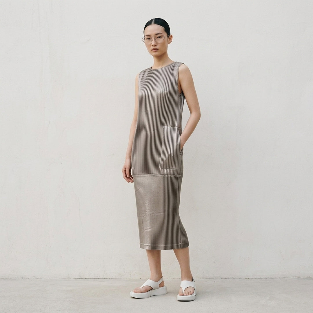 Black sleeveless glossed pleated midi dress by Issey Miyake with a round neckline and paneled seams - lifestyle