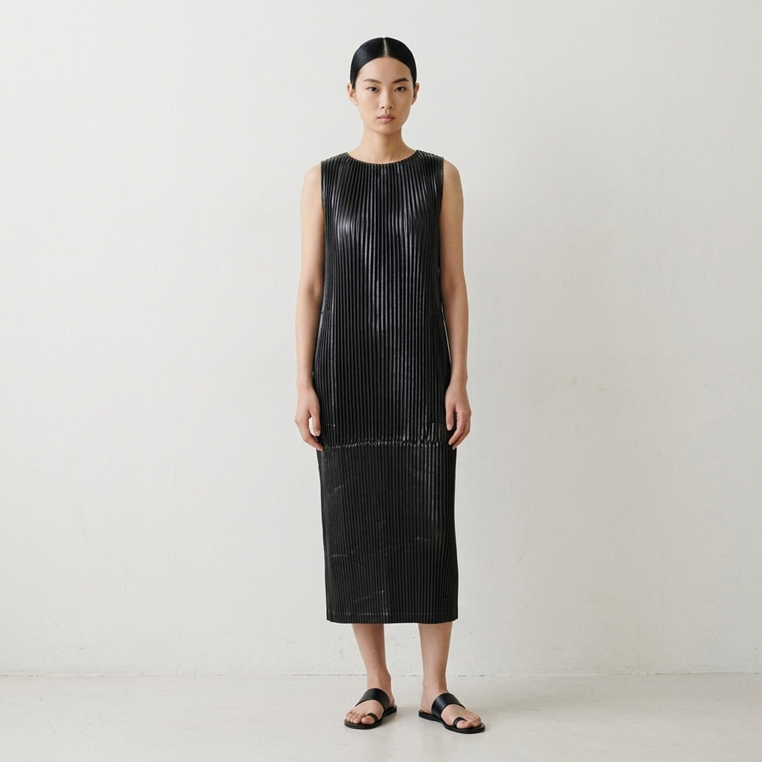 Black sleeveless glossed pleated midi dress by Issey Miyake with a round neckline and paneled seams - lifestyle