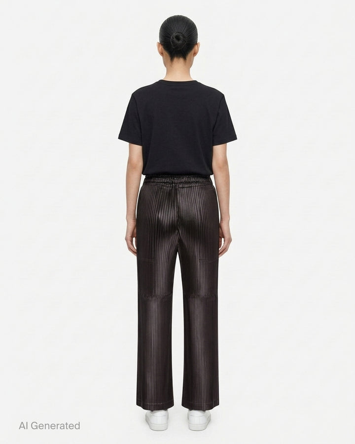 Issey Miyake glossed panels pleated pants in a metallic grey finish with an elasticated waist and wide-leg silhouette, shown from the front - back