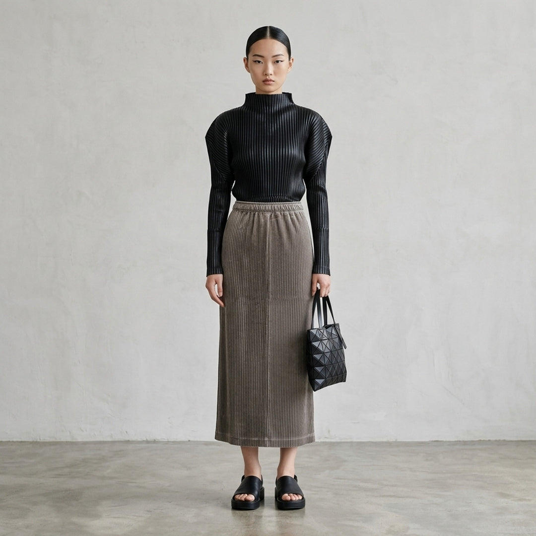 Issey Miyake Glossed Panels Pleated Skirt in black with fine vertical pleats, panelled seam detail and elasticated waistband - lifestyle