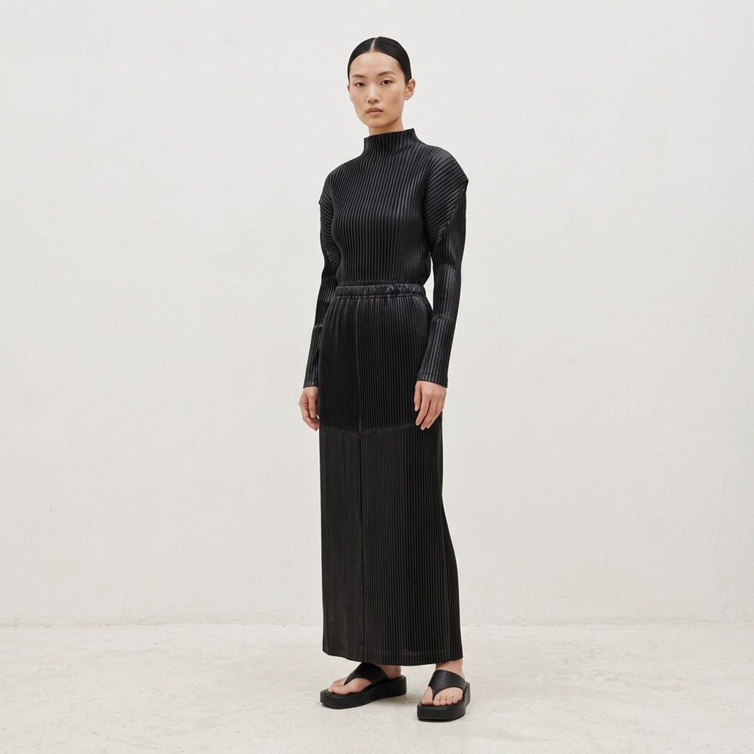Issey Miyake Glossed Panels Pleated Skirt in black with fine vertical pleats, panelled seam detail and elasticated waistband - lifestyle