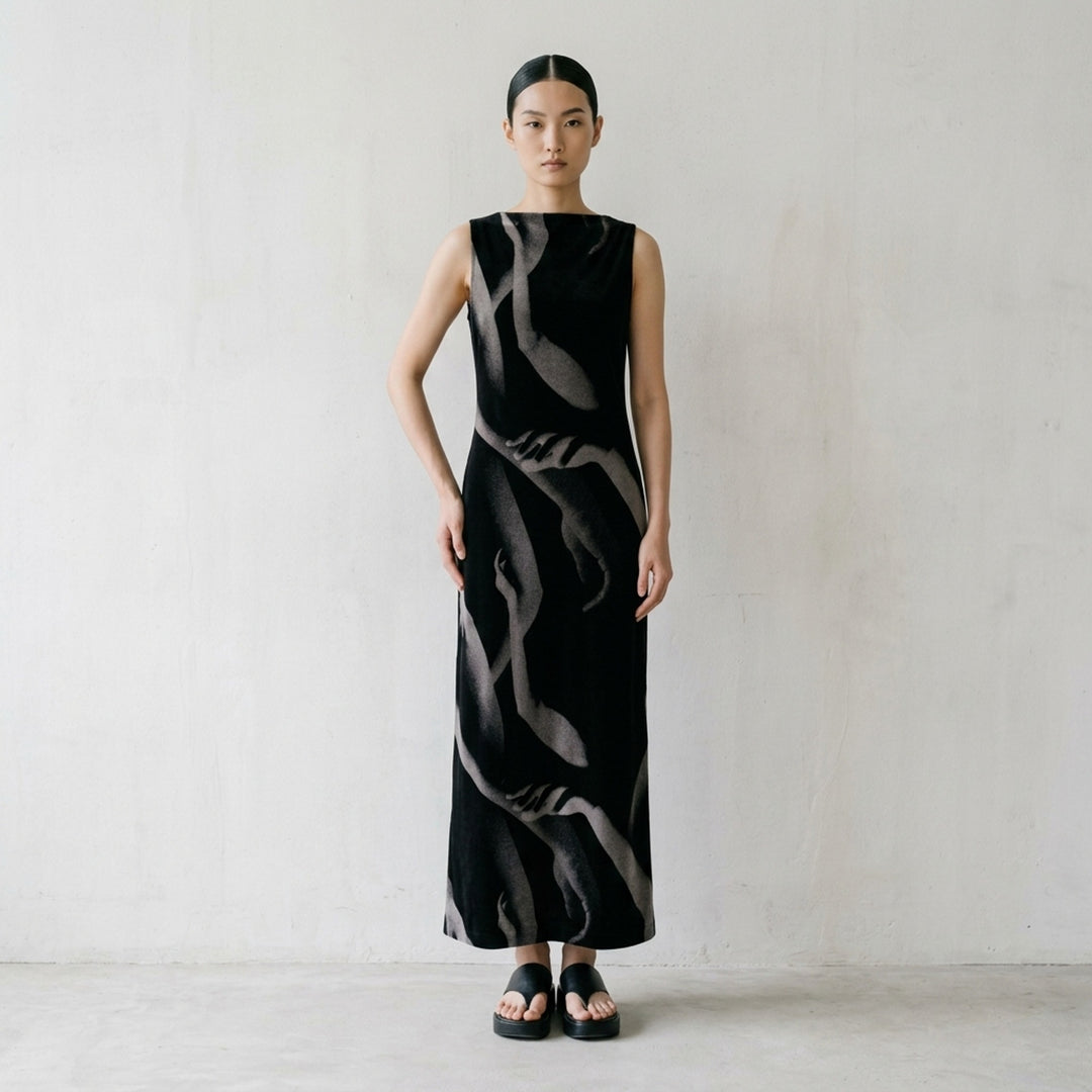 Issey Miyake Hands of Lover sleeveless black velour knit maxi dress with all-over grayscale photographic print of intertwining human arms and hands - lifestyle