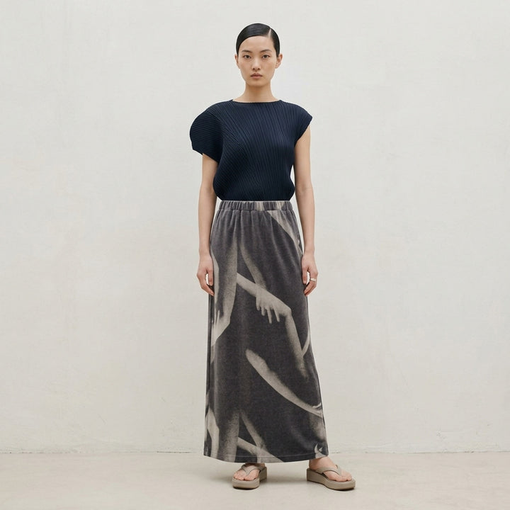Issey Miyake Hands of Lover black velour maxi skirt with an allover monochromatic photographic print of intertwined arms and hands, shown flat against a white background - lifestyle