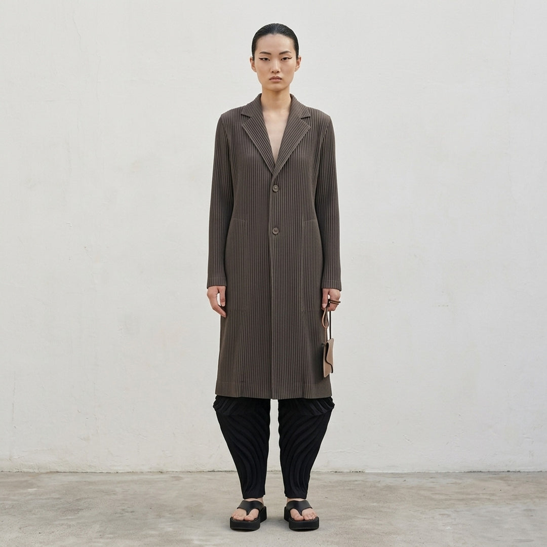 Issey Miyake Hatching Pleats long black pleated coat with notched lapel and two-button front - lifestyle