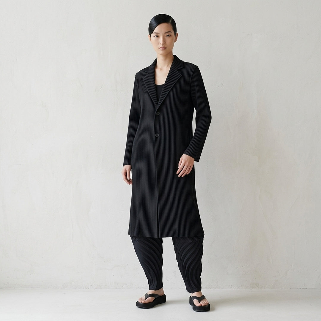 Issey Miyake Hatching Pleats long black pleated coat with notched lapel and two-button front - lifestyle