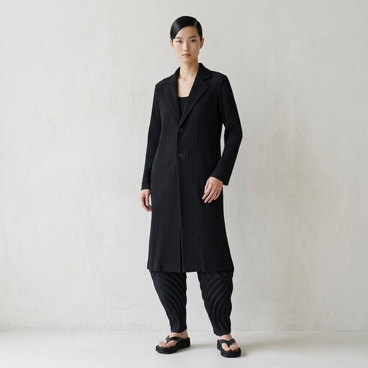 Issey Miyake Hatching Pleats long black pleated coat with notched lapel and two-button front - lifestyle