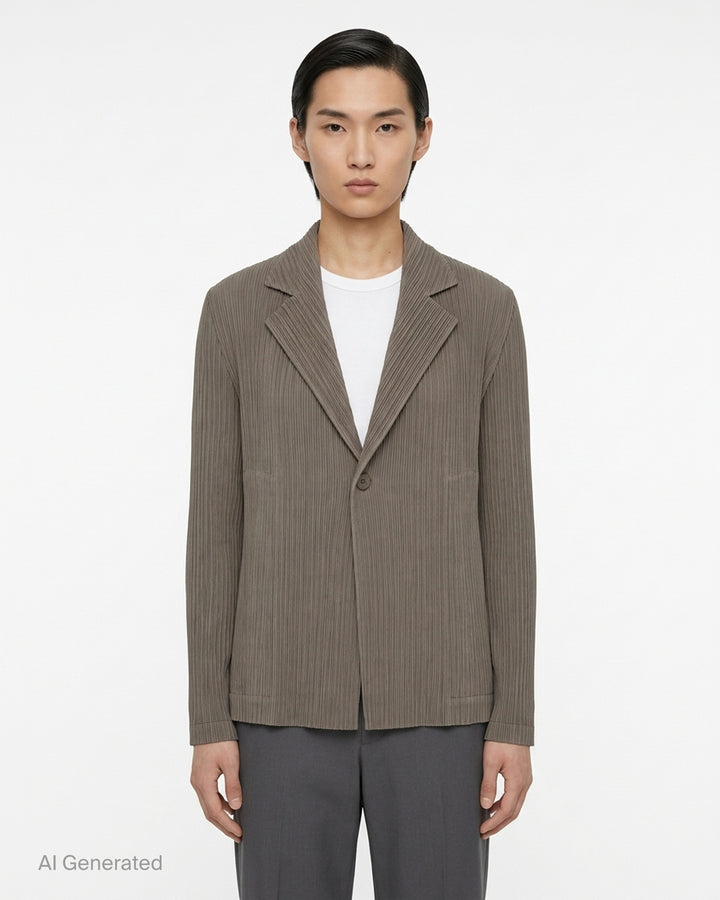 Black pleated single-button jacket with notched lapels by Issey Miyake, shown from the front - front