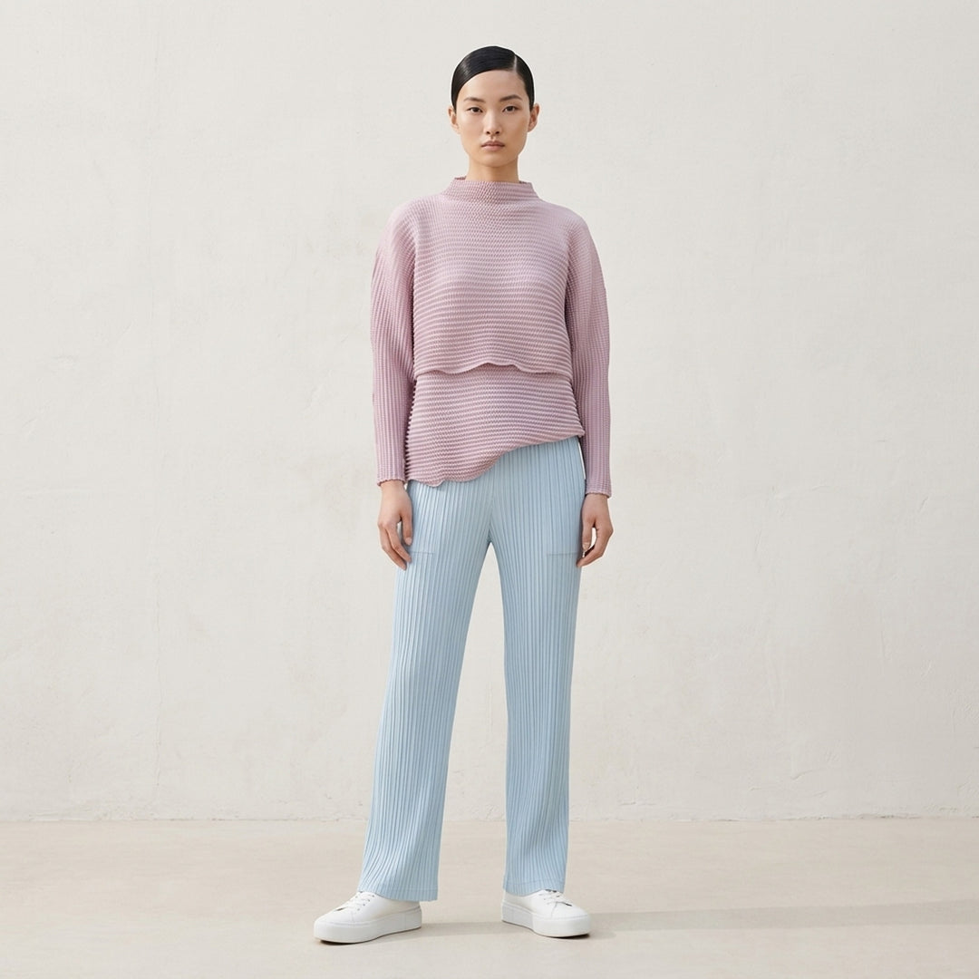 Issey Miyake Hatching Pleats pleated pants in muted taupe-grey with elasticated waist, patch pockets and straight leg, front view - lifestyle