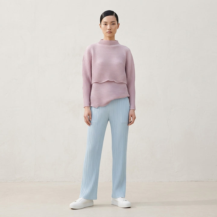 Issey Miyake Hatching Pleats pleated pants in muted taupe-grey with elasticated waist, patch pockets and straight leg, front view - lifestyle