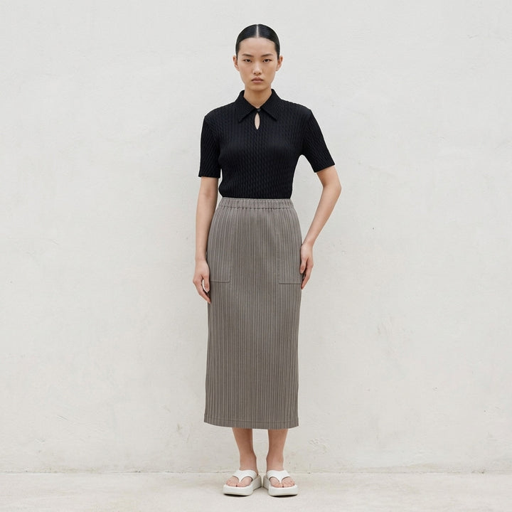 Issey Miyake Hatching Pleats black pleated midi skirt with elasticated waist, front view - lifestyle