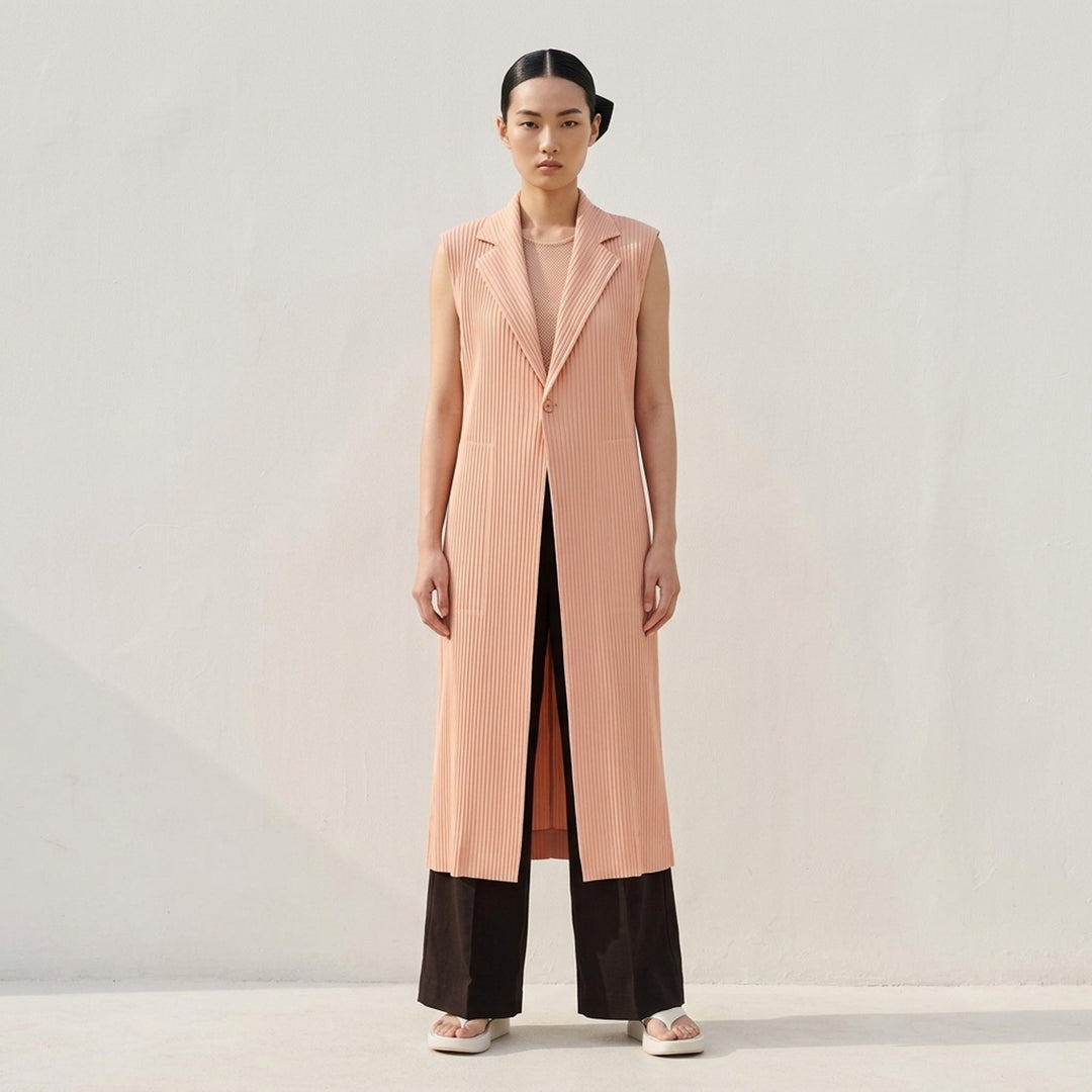 Issey Miyake Hatching Pleats long sleeveless vest in blush pink with notched lapel, single button and hip pockets in fine vertical pleats - lifestyle