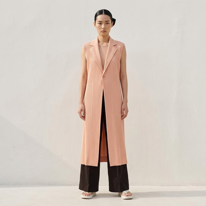 Issey Miyake Hatching Pleats long sleeveless vest in blush pink with notched lapel, single button and hip pockets in fine vertical pleats - lifestyle