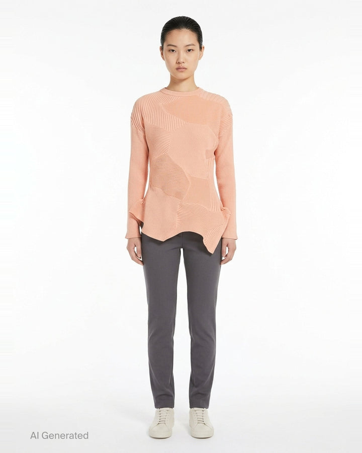 Issey Miyake KONE KONE black knit top with multi-directional ribbed panels, asymmetric pointed hem, and long sleeves — rear view on white background - front