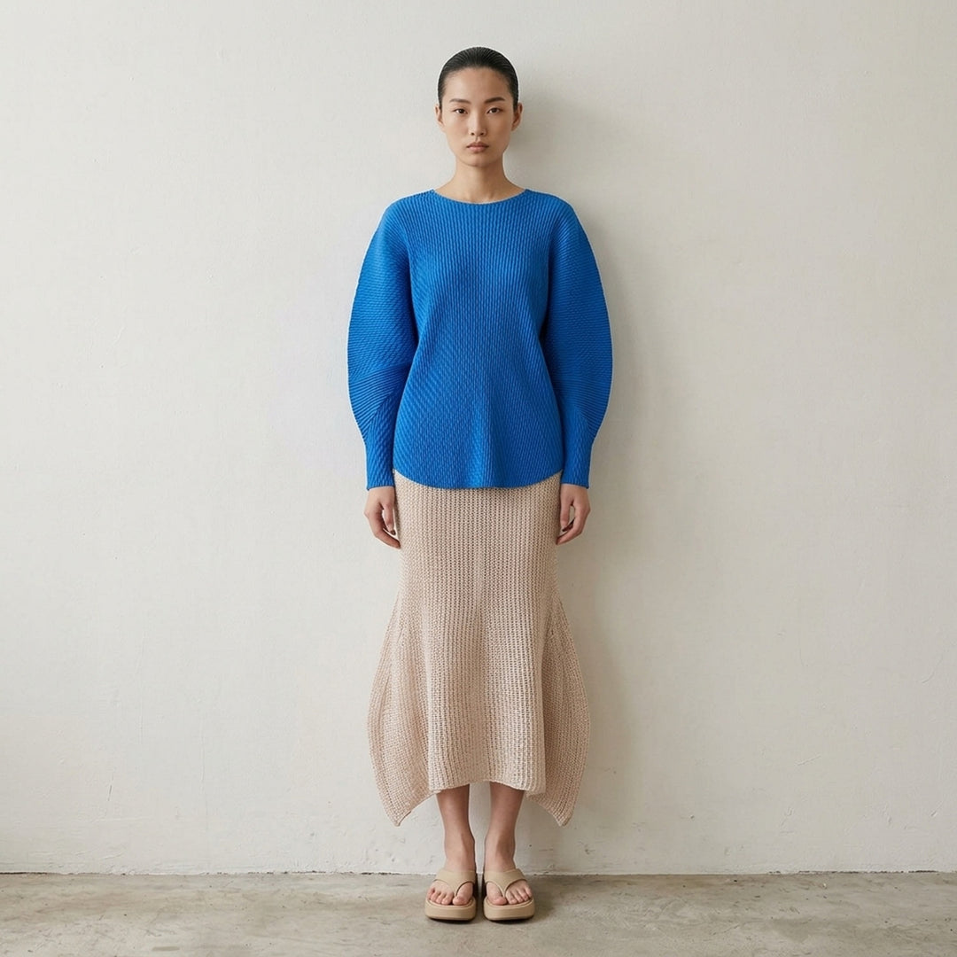 Issey Miyake Panini Pulled black open-weave sheer knit midi skirt with ribbed waistband and flared petal-shaped side panels, front view - lifestyle
