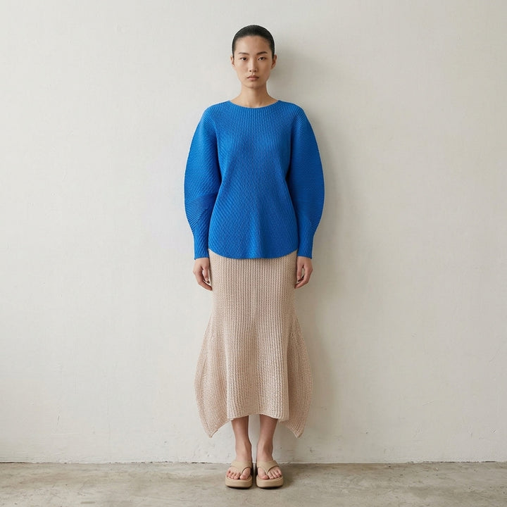 Issey Miyake Panini Pulled black open-weave sheer knit midi skirt with ribbed waistband and flared petal-shaped side panels, front view - lifestyle