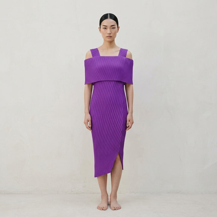Issey Miyake Tubular Pleats black micro-pleated cold-shoulder midi dress with foldover bodice, wide straps, and asymmetric hem, displayed flat on white background - lifestyle