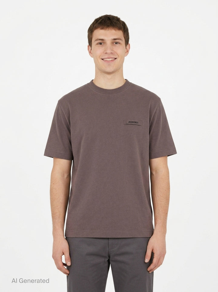 Jacquemus Le T-shirt Gros Grain in pale yellow, featuring a relaxed fit, crew neck, short sleeves, and a woven Jacquemus grosgrain logo tab on the chest - front