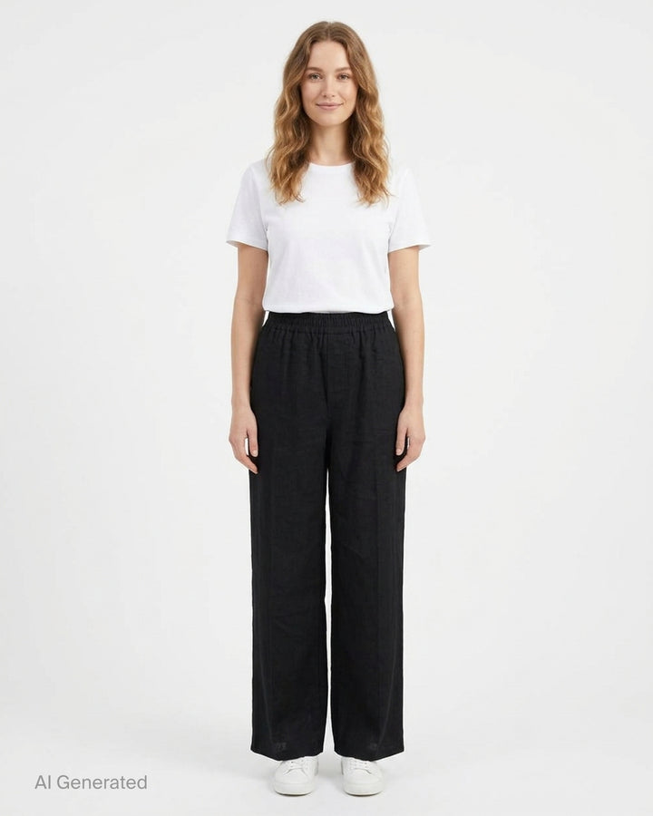 Jacquemus Miami black wide-leg trousers with a smocked elasticated waistband, shown from the front - front