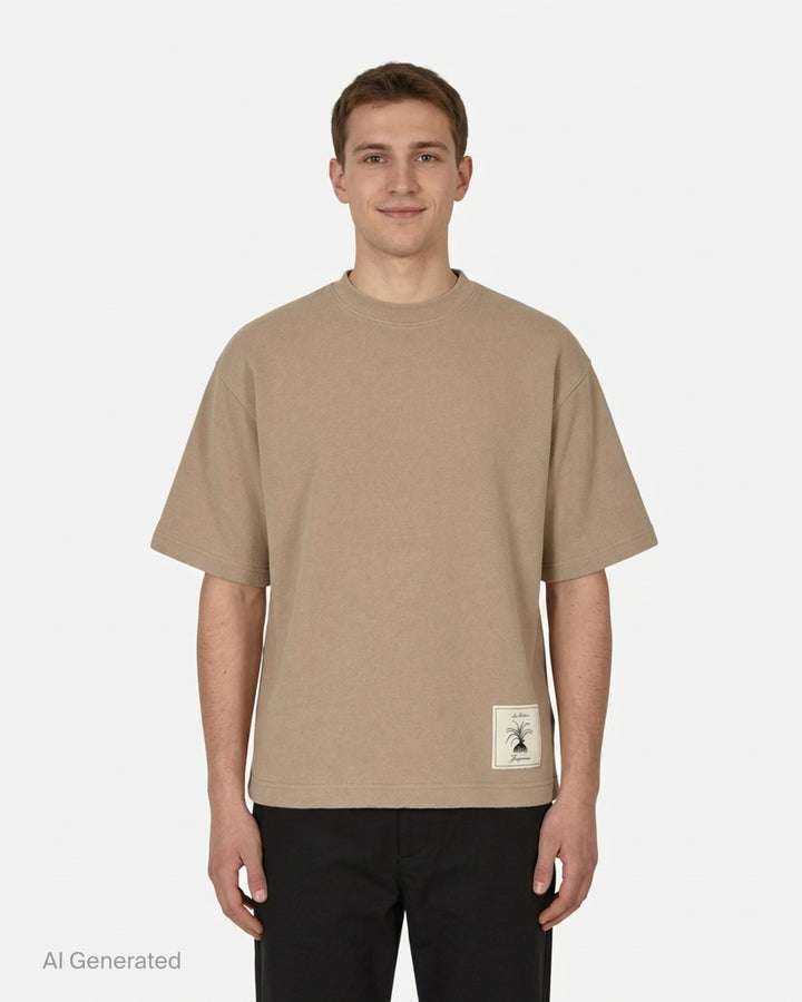 Jacquemus Le T-shirt Torneo short sleeve tee in taupe with a woven botanical label at the hem - front