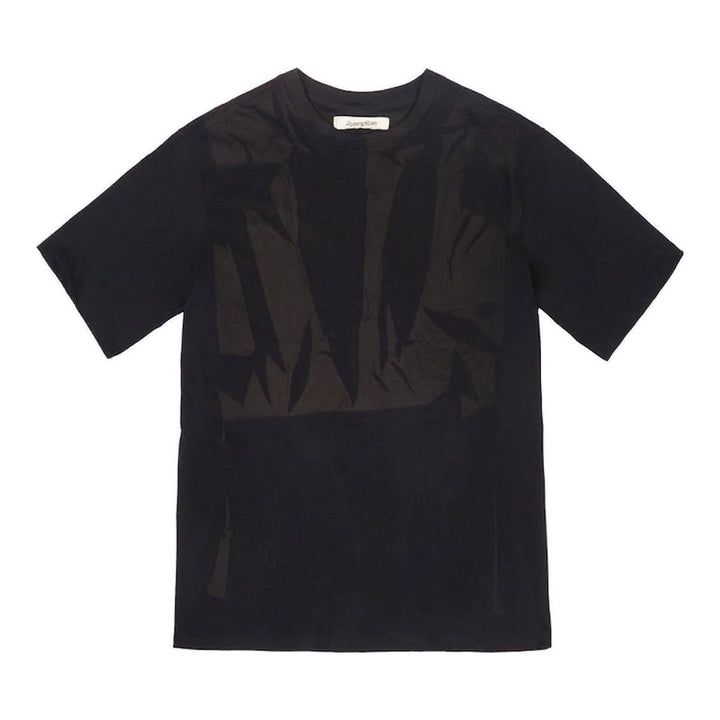 JiyongKim Sun-Bleached Pack Tee in black, flat lay front view showing crinkled nylon tonal appliqué panels across the chest on an oversized short sleeve silhouette - packshot