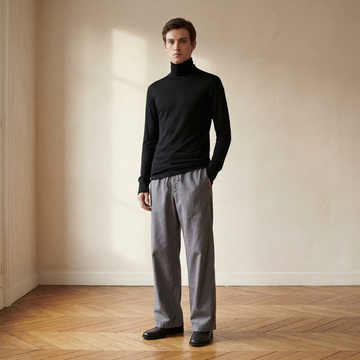 Lemaire black wool silk jersey turtleneck top with long sleeves and ribbed cuffs, shown front view - lifestyle
