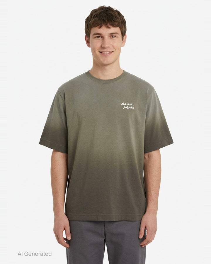 Maison Kitsuné Handwriting Short Sleeve Tee in washed slate blue with embroidered script logo at the chest, shown front-facing on a plain white background - front