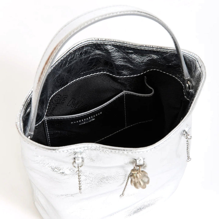 Marge Sherwood Wired Bucket Bag in crinkled metallic silver leather with a slim top handle and gold-tone charm on chain - packshot