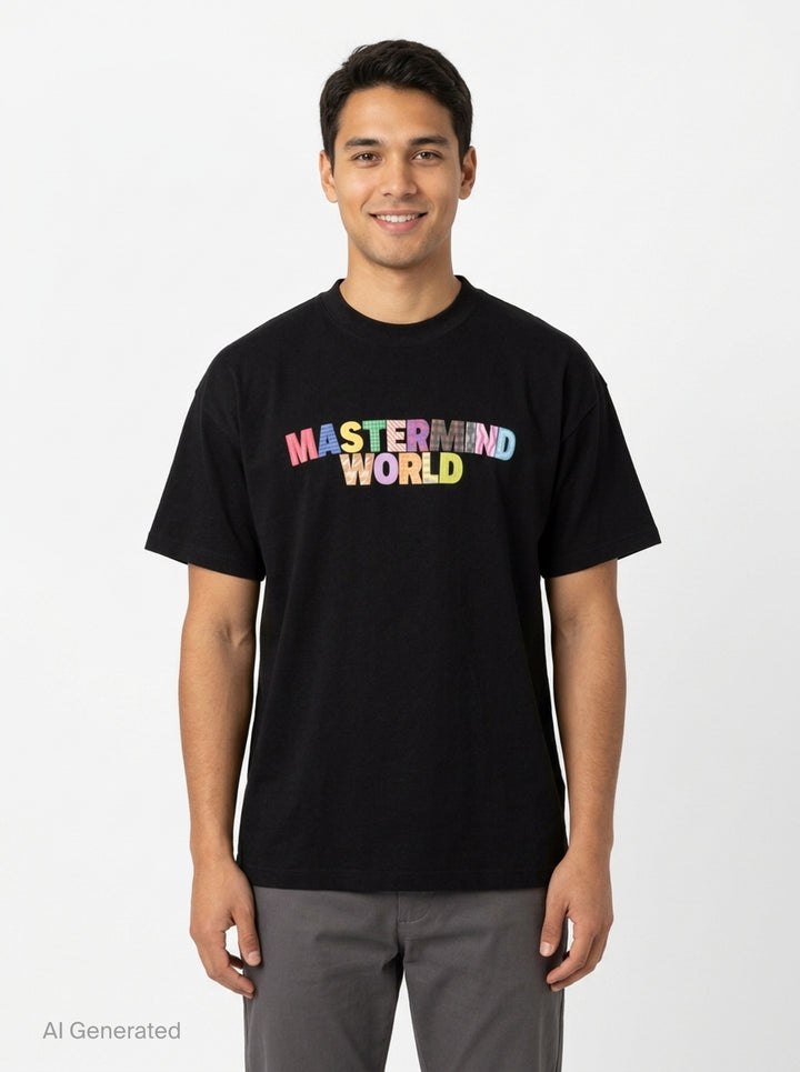 Mastermind World black boxy short sleeve tee with multicolour plaid-patterned arched logo wordmark printed across the chest - front