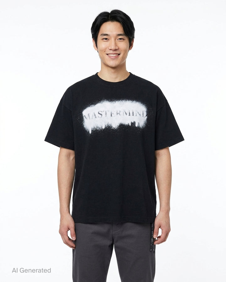 Mastermind black short sleeve tee with a white spray-paint stencil logo graphic on the chest and a logo drawcord at the hem - front