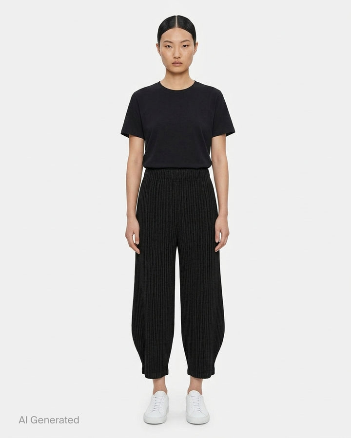 me Issey Miyake Corduroy Pleats black ribbed pleated pants with elasticated waist and curved, tapered leg, front view - front