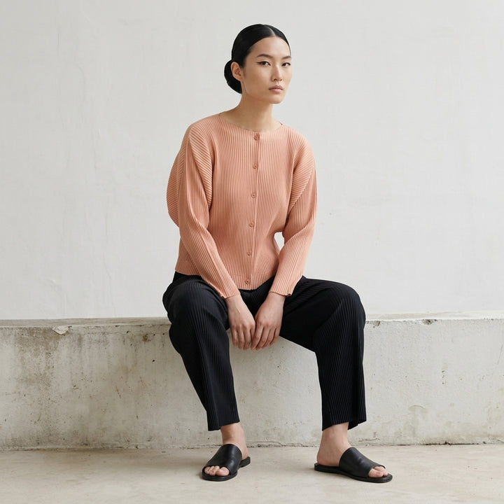 me Issey Miyake Fine Knit Pleats Cardigan in sky blue, shown from the back, featuring signature all-over pleated texture and a button placket fastening along the centre back - lifestyle