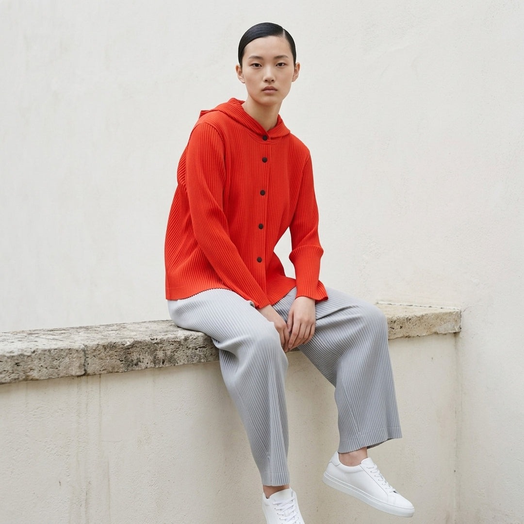 me Issey Miyake Fine Knit Pleats Color 2 blouson in slate grey, featuring vertical pleating, an attached hood, and tonal snap button-front closure - lifestyle