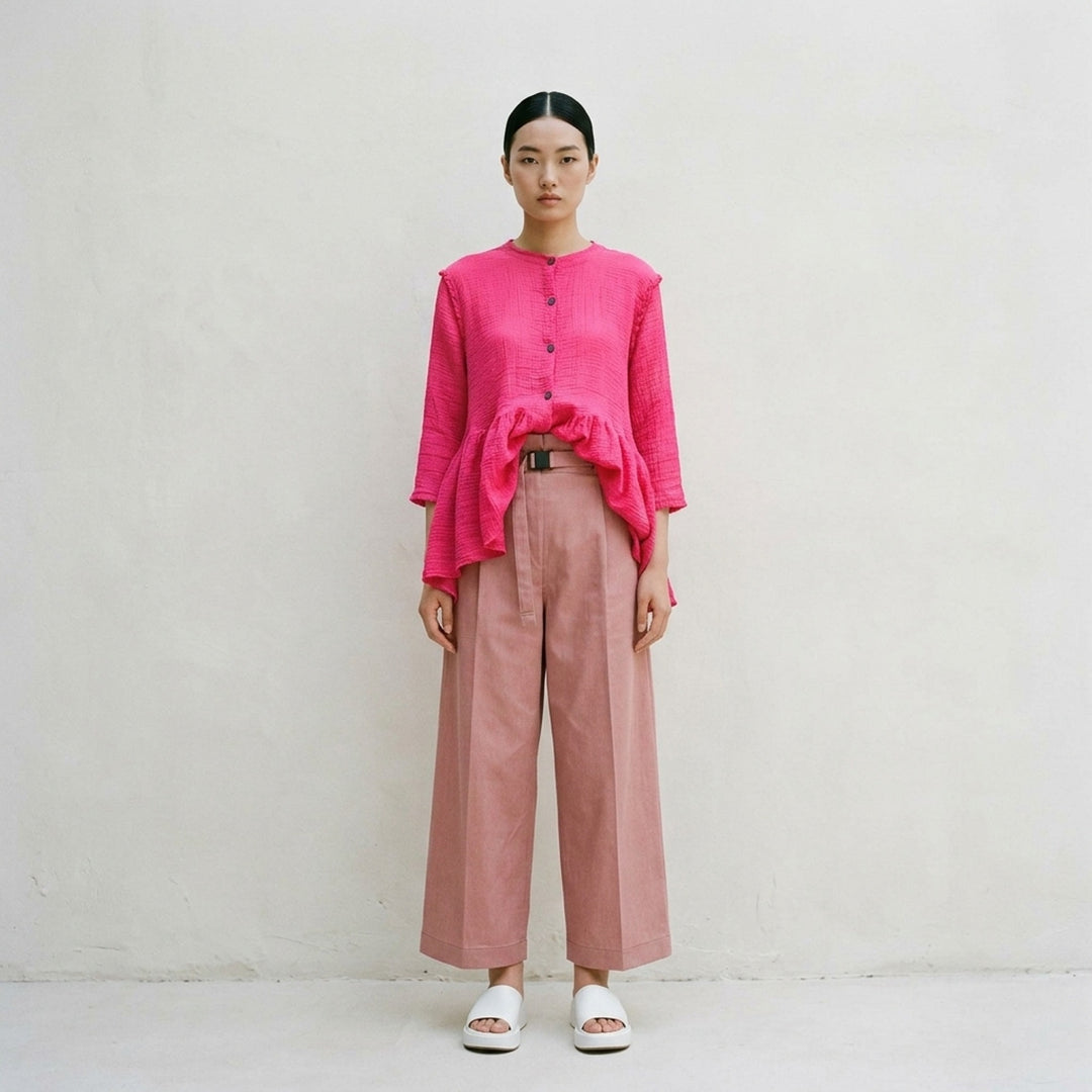 me Issey Miyake Flat Denim Seasonal Pants in dusty rose — wide-leg culotte silhouette with front pleats, utility clip buckle waistband, and cuffed hem, shown flat against a white background - lifestyle